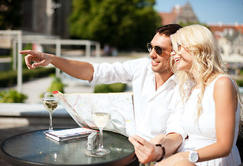 Image showing couple with map in cafe