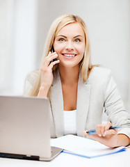 Image showing businesswoman with laptop and cell phone