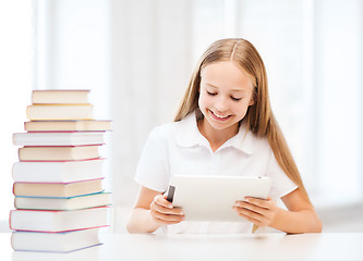 Image showing girl with tablet pc and books at school