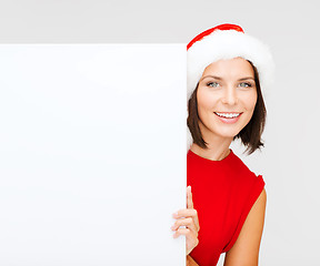 Image showing woman in santa helper hat with blank white board