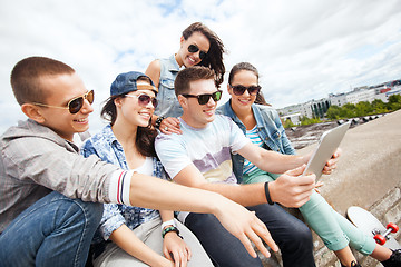 Image showing group of teenagers looking at tablet pc