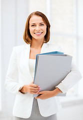 Image showing businesswoman with folders in office