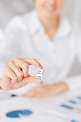 Image showing man hands with gambling dices signing contract