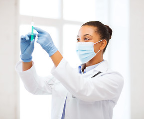 Image showing african doctor holding syringe with injection