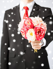 Image showing man giving bouquet of flowers