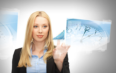 Image showing businesswoman pointing at graph clock