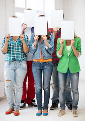 Image showing students covering faces with blank papers