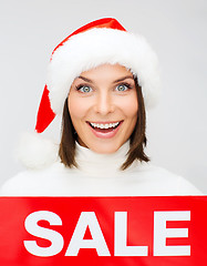 Image showing woman in santa helper hat with red sale sign