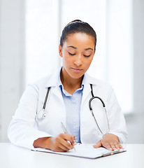 Image showing female doctor writing prescription