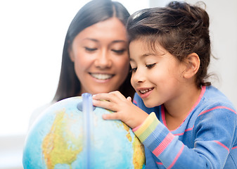 Image showing mother and daughter with globe