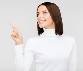 Image showing woman in white sweater pointing to something