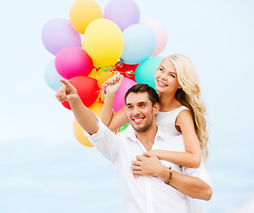 Image showing couple with colorful balloons at sea side
