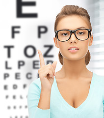 Image showing woman in eyeglasses with eye chart