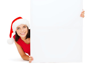 Image showing woman in santa helper hat with blank white board