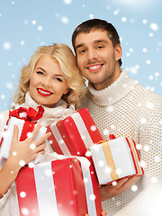 Image showing happy man and woman with many gift boxes