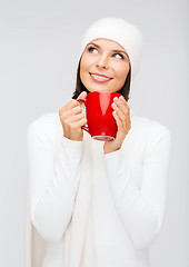 Image showing woman in hat with red tea or coffee mug