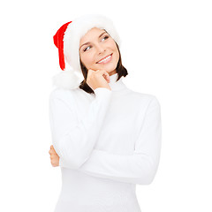 Image showing thinking and smiling woman in santa helper hat