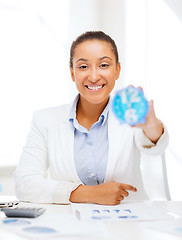 Image showing businesswoman working with calculator in office