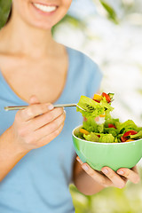 Image showing woman eating salad with vegetables