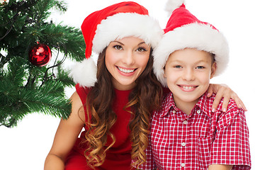 Image showing happy mother and child boy in santa helper hats