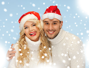 Image showing family couple in sweaters and santa's hats