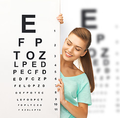 Image showing woman in eyeglasses with eye chart