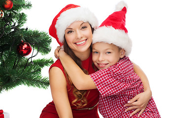 Image showing happy mother and child boy in santa helper hats