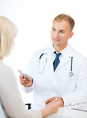 Image showing doctor giving tablets to patient in hospital