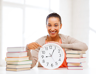 Image showing attractive woman with white clock