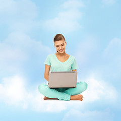 Image showing woman sitting on the cloud with laptop