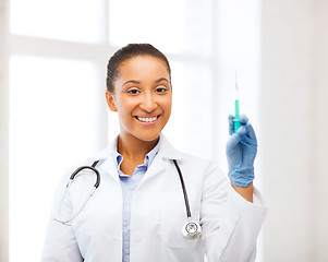 Image showing african doctor holding syringe with injection