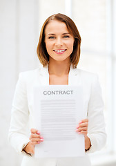 Image showing businesswoman holding contract