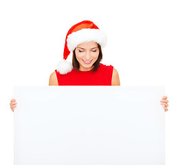 Image showing woman in santa helper hat with blank white board