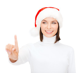 Image showing woman in santa helper hat pressing vitrual button