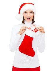 Image showing woman in santa hat with gift box and stocking