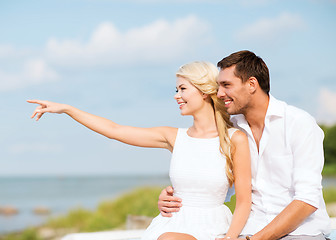 Image showing couple sitting at sea side