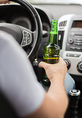 Image showing man drinking alcohol while driving the car