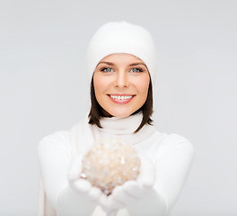 Image showing woman in hat and gloves with christmas ball