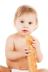 Image showing cute todler eating long bread