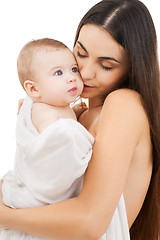 Image showing mother kissing adorable baby