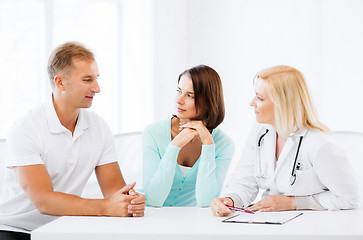 Image showing doctor with patients in cabinet