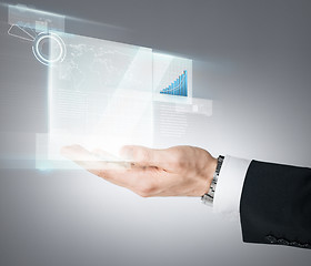 Image showing businessman hand showing chart on virtual screen