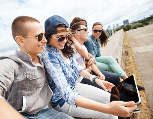 Image showing group of teenagers looking at tablet pc