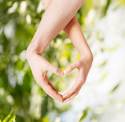 Image showing woman and man hands showing heart shape