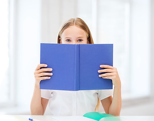 Image showing girl studying and reading book at school