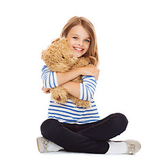 Image showing cute little girl hugging teddy bear