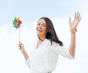 Image showing girl with windmill toy on the beach