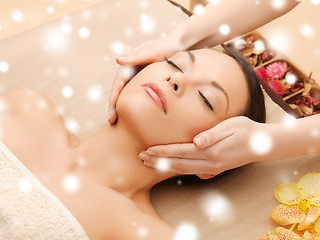 Image showing woman in spa salon lying on the massage desk