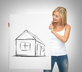 Image showing woman holding picture with house