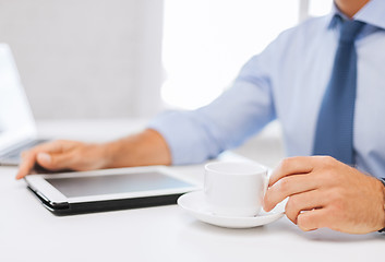 Image showing businessman with tablet pc and coffee in office